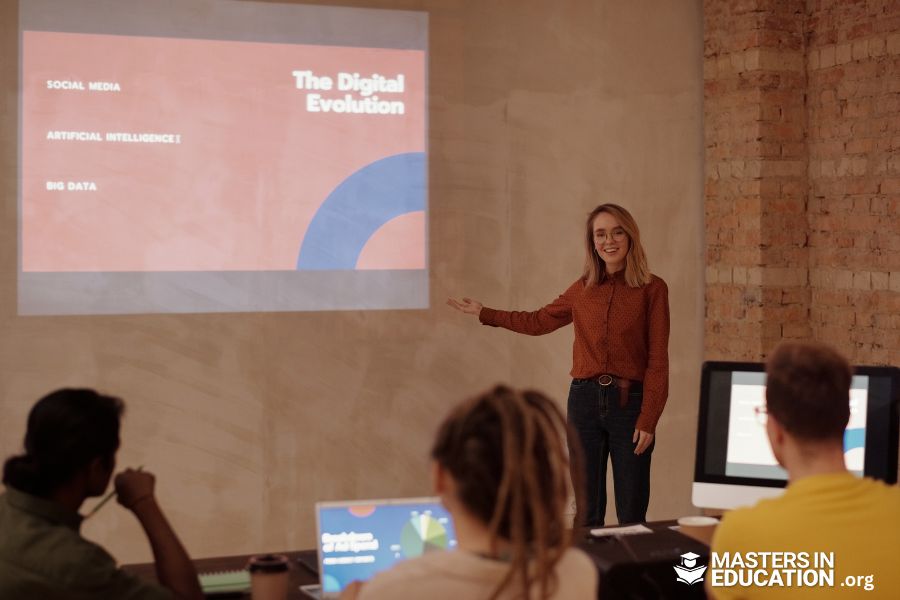 a woman standing in front of a projector screen